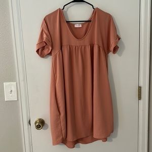 Woman’s blush pink babydoll dress with pockets